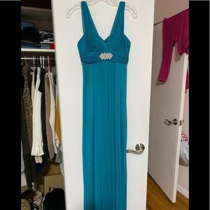 Teal long gown with rhinestone brooch